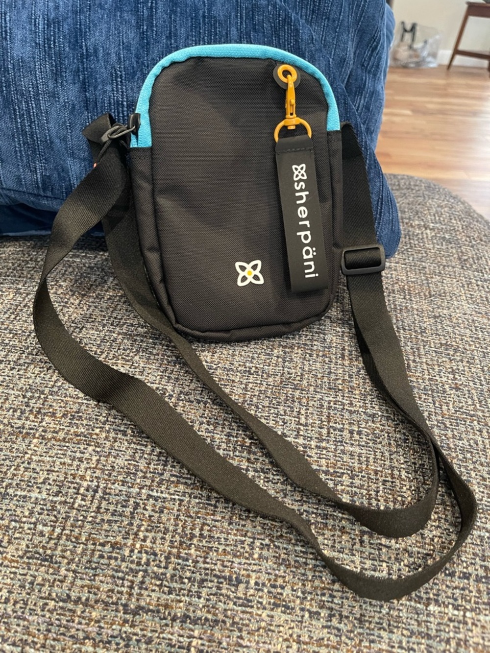 NWOT...Sherpani Black Crossbody Pouch with Teal Accent and Yellow Hardware